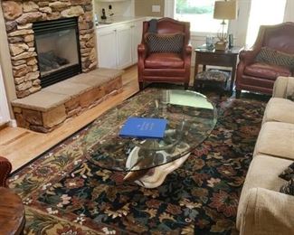 Beautiful Wool Carpet. Designer/Artist Glass and Fish Table. Leather Chairs. Sofa and more wonderful items.