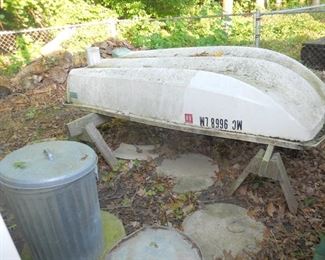one of 2 dinghys, metal trash can, patio stones