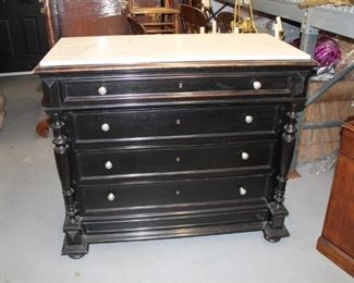 20th c. Ebonized  Commode, the front with  two mounted  carved column forms  with white Marble Top;  4 drawers with pewter pulls 