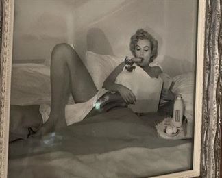 VINTAGE BLACK AND WHITE PHOTOGRAPH, STAMPED BY ANDRE DE DIENESS OF  MARILYN MONROE, "Breakfast in Bed", 1953. Gelatin Silver Print. SW32232 cm, full length, right knee up, with carrot in mouth looking at paper 