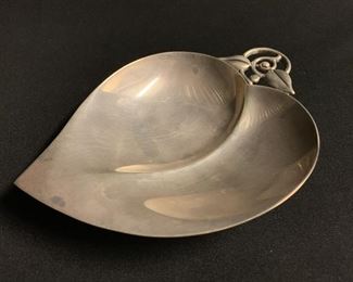 A TIFFANY AND CO HAND WROUGHT STERLING ART DECO NUT DISH, Designed in the Jensen style with curling tendril handle.  Condition:  Very good