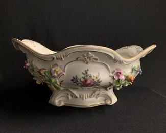 DRESDEN ROCCOCO STYLE ENAMELED AND APPLIQUED PORCELAIN MONTIFF, Of cartouche form enameled with reserves of colorful flowers alternating with appliques of fluted and flowering vines . Condition: Very Good