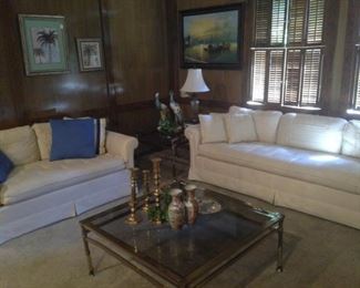 White sofa and one of two matching loveseats
