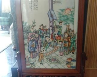 Hand painted Asian porcelain fire screen in hand carved wooden frame.