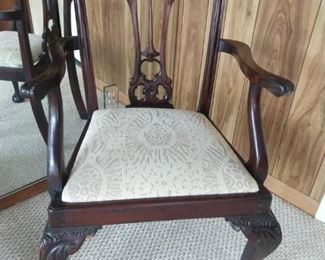 One of a pair of finely carved Victorian English mahogany armchairs.