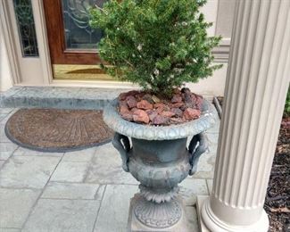 One of a pair of one-piece cast aluminum planters.