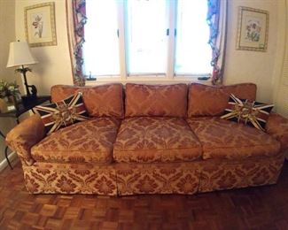 Swell sofa, with English tapestry Union Jack & heraldic crest pillows.