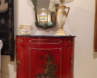 Here's a close-up of one of the pair of Chinese red demilunes, along with the "Lisa Douglas" white princess telephone, avocado green wooden French wall mirror and Italian Florentine table lamp.