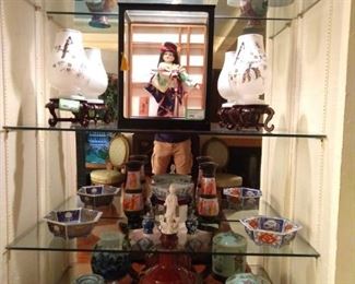 Glass shelves filled with more good, Asian porcelains and cloisonne.