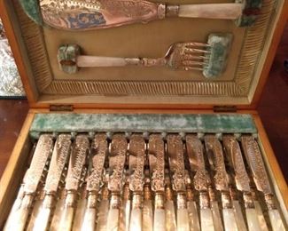 I'll tell you. It's an 1870 Sheffield Victorian fish set, in original satin-lined casket box, with set of 12 MOP knives & forks with deeply engraved  blades and tines and one each large serving knife/fork.                                  See, it does look like a casket.