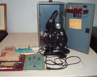 A.O. Spencer professional microscope with locking case, manual and supplies.