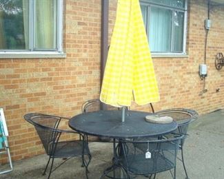 Wrought iron patio set with new umbrella.