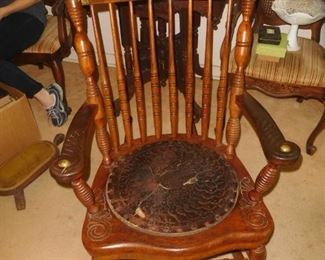 Antique rocker with brass adornments