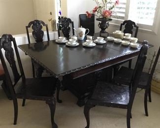 heavily carved beautiful Brazilian walnut vintage dining table set in excellent original condition. Set includes eight chairs ( two armchairs +6 side chairs) and two leaves– all chairs heavily carved Brazilian walnut with embossed leather insert seats – price $395