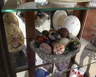 carved ostrich egg back right $90, egg shaped figurine hand-painted back left side $22 and mixed media and natural stone egg collection $8 to $18 each.