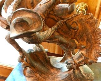 High chaparral cowboy on bucking bronco sculpture