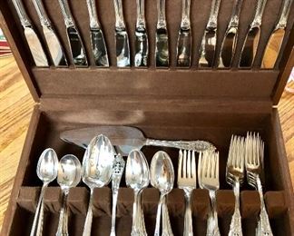 Service for twelve sterling silver flatware, by Wallace.  The pattern is Rosepoint.   The set includes serving pieces, ice tea spoons, soup spoons and much more. 