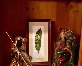 African mask, Indian statue, feather artwork