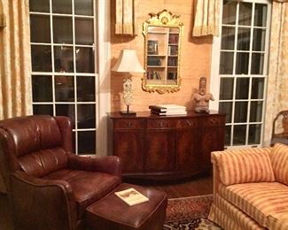 Leather club chair with matching ottoman, Baker mahogany sideboard