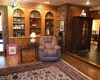 Family room view with lazyboy recliner, KY LBL table, English Oak wardrobe, Persian rug with animals in design
