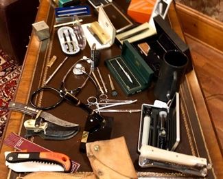 overview of pens, knives, medical instruments, and mini German Camera