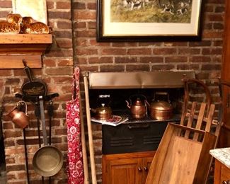 Kitchen Fireplace wall view with copper, antique brass ladle, antique wood market sleigh.