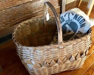 very old wicker basket photographed with a flour sack 