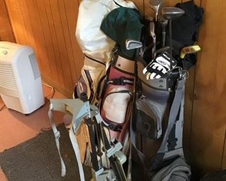 3 Sets of Golf Clubs and a Cart