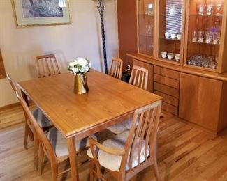 MCM teak Danish dining room table and hutch.  Table has 2 built in leaves. 55" Long or 95" Long with both leaves. Hutch is 2 pcs. 80" w at the base, 73" h