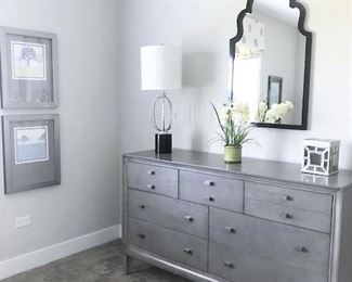 Dresser, mirror, lamps, home decor, wall art.
