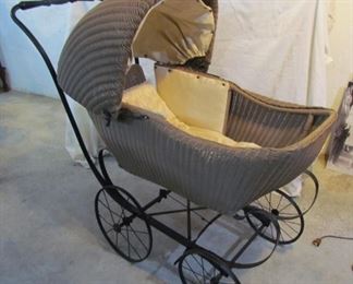 Large, wicker baby buggy, with springs.