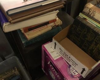 Books , box of magazines and an open back book shelf.