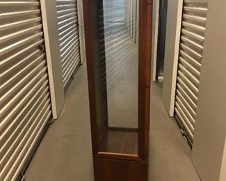 Glass lighted display Cabinet. Has 2 shelves, pegs, lock and key. Crack on one side of glass at bottom.