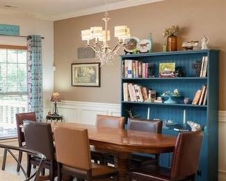 Stylish and modern best explains this Dining Room. Our three-shelf repurposed solid wood Turquoise Hutch is stylish and functional. Featured with a beautiful Oak Table and Leather Chairs makes this stylish blend work with this country charm home.