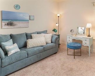 Gorgeous Turquoise three cushion Sofa with matching throw pillows. Vintage Mid Century Modern round Stool and a Vintage Cosmetic Desk with Pop-Up Mirror. 