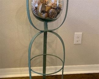Stand with beautiful shells and lighted candle in center