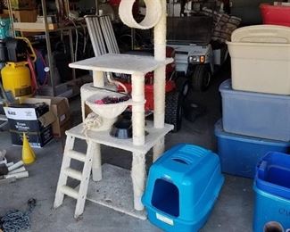 cat condo with toys and a litter box