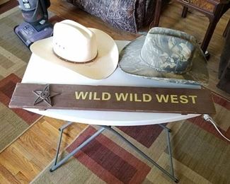 2 cowboy hats and wild wild west sign