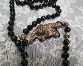 One of a kind black onyx bead necklace with 14k gold spacers carved stone monkey pendant.