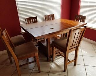 60 inch long, solid wood table with center leaf, center storage drawer and 6 chairs.