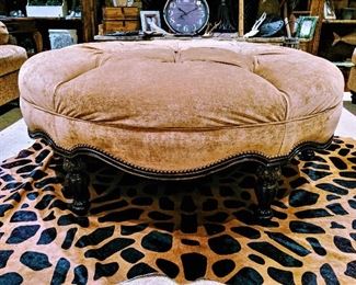 large round tufted ottoman and animal print cowhide rug