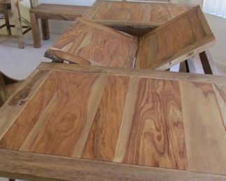 Dining table with extensions that fold under the top