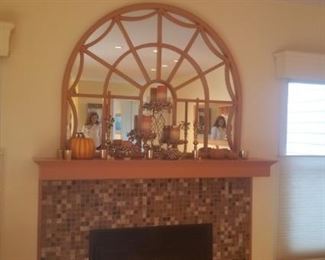 Above fireplace arch mirror with decorative items