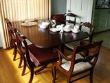 Mahogany dining table and six chairs, with four extra leaves.