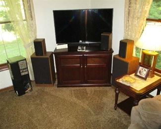 Flat screen television, stereo speakers, entertainment center