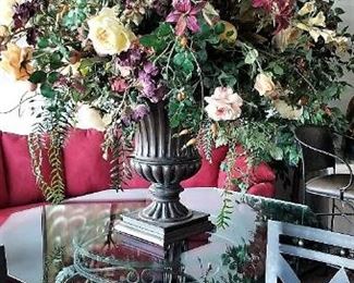 Octagon glass dining table with metal base and very large sophisticated floral decor.