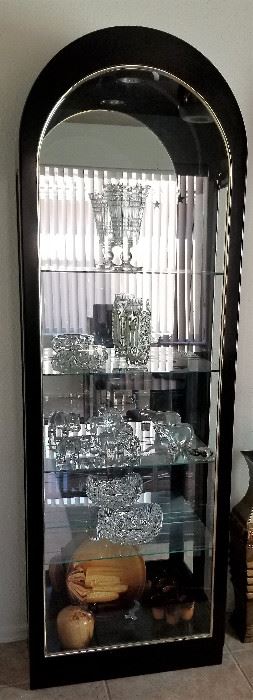 Lighted curio cabinet with mirrored back.