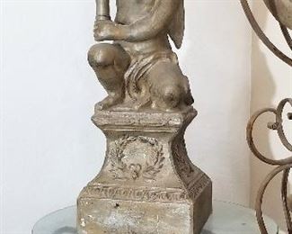 Metal cherub holding torch which can hold a candle. Round glass and metal table. We also have bar stools.