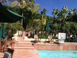 Teak furnishings, built-in BBQ and outdoor appliances, potted plants and outdoor pool/ping pong table!