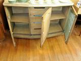 Check out the wonderful, vintage buffet style cabinet with three doors. Behind the middle door contains four drawers. Great storage and great piece!